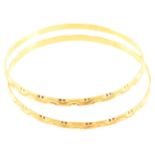 Two yellow metal slave bangles, 3.3mm wide, internal diameter 62mm, bright