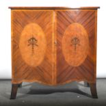 A reproduction inlaid mahogany serpentine front cabinet, with banding and s