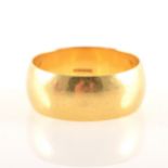 An 18 carat yellow gold wedding band, 9mm wide plain polished D shape, appr