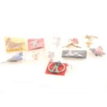 Eleven Art Deco and 1950's pins and brooches, dancing and sports girls, gol