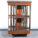 Edwardian style mahogany revolving bookcase, square top with satinwood cros