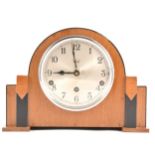 An Art Deco walnut and ebonised mantel clock, silvered dial, marked Flinn &
