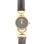 Gucci - a lady's wristwatch, circular black dial in a gold-plated case with