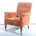 A Victorian easy chair, upholstered back and arms, turned legs on castors,