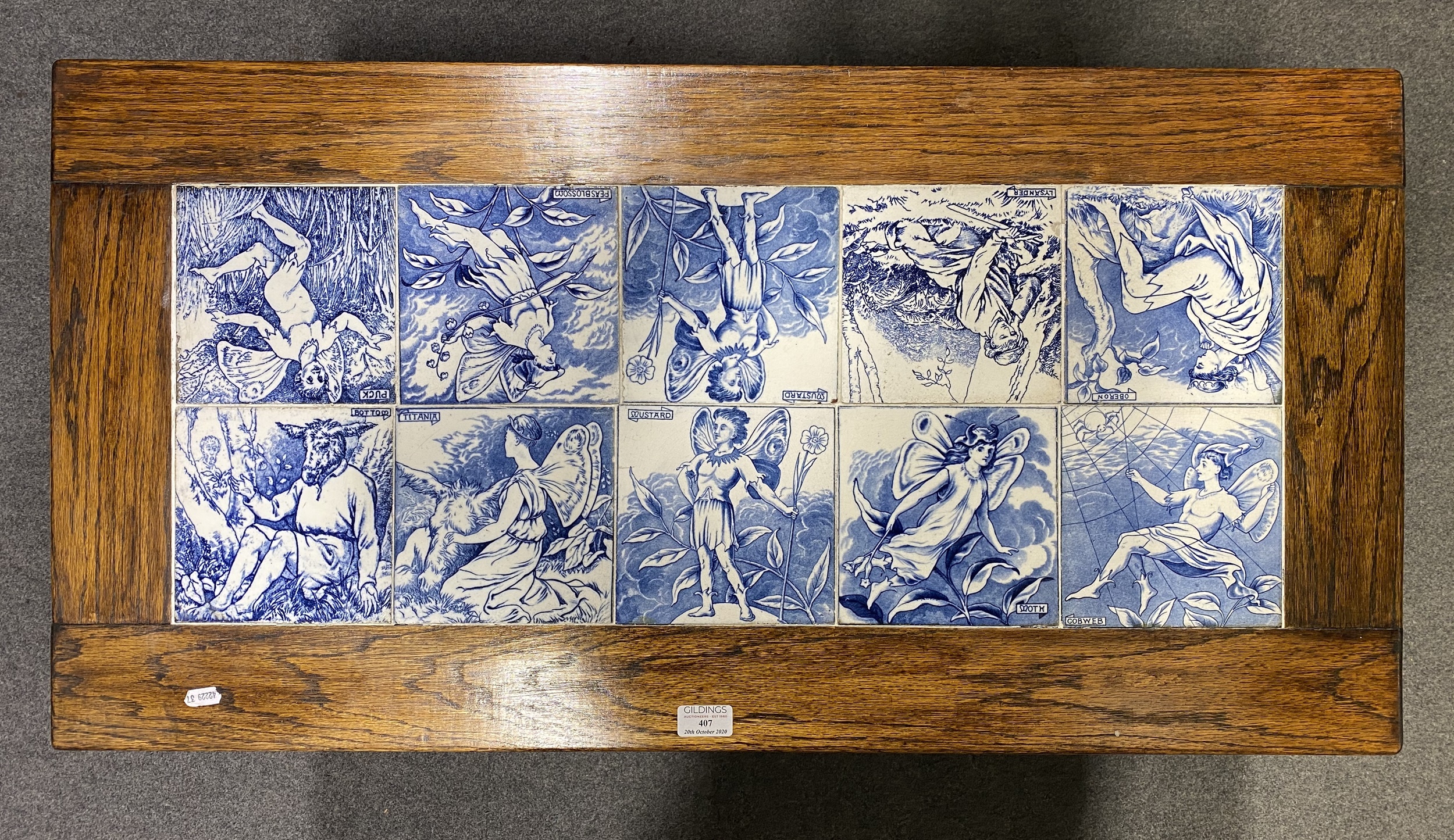 An oak side table inset with eight Victorian 6" decorative tiles, Shakespea