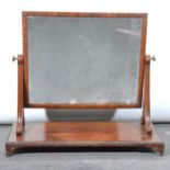 A Victorian mahogany toilet mirror, adjustable rectangular plate, on scroll