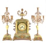 French onyx and gilt metal three-piece clock garniture, ivorine dial, signe