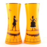 A pair of amber tinted vases, Mary Gregory style silhouette painted figures