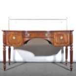 A Regency mahogany bowfront sideboard with brass rail back, with central fr