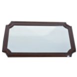 A mahogany framed wall mirror, rectangular bevelled plate with canted corne