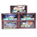 Five boxed Scalextric slot-car racing models.