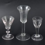 A wheel-engraved cordial glass and two wine glasses