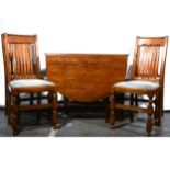 An oak drop leaf table and six chairs,