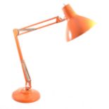 A 1960's orange angle poise lamp by 1001 Lamps London.