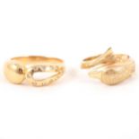 Two modern gold dress rings.