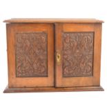 An Edwardian oak smokers cabinet