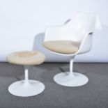 A 'Tulip' armchair, designed by Eero Saarinen, and matching footstool