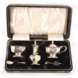 A cased three piece silver condiment set.