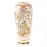 A Japanese Satsuma slender vase decorated with figures and trailing wisteria.