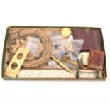 A tray of collectables, napkin clip, buttons, photo frame, small purse, compass.