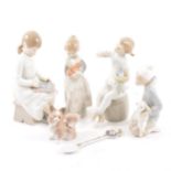 Four Lladro figures, children and a small dog, an unmarked spoon.