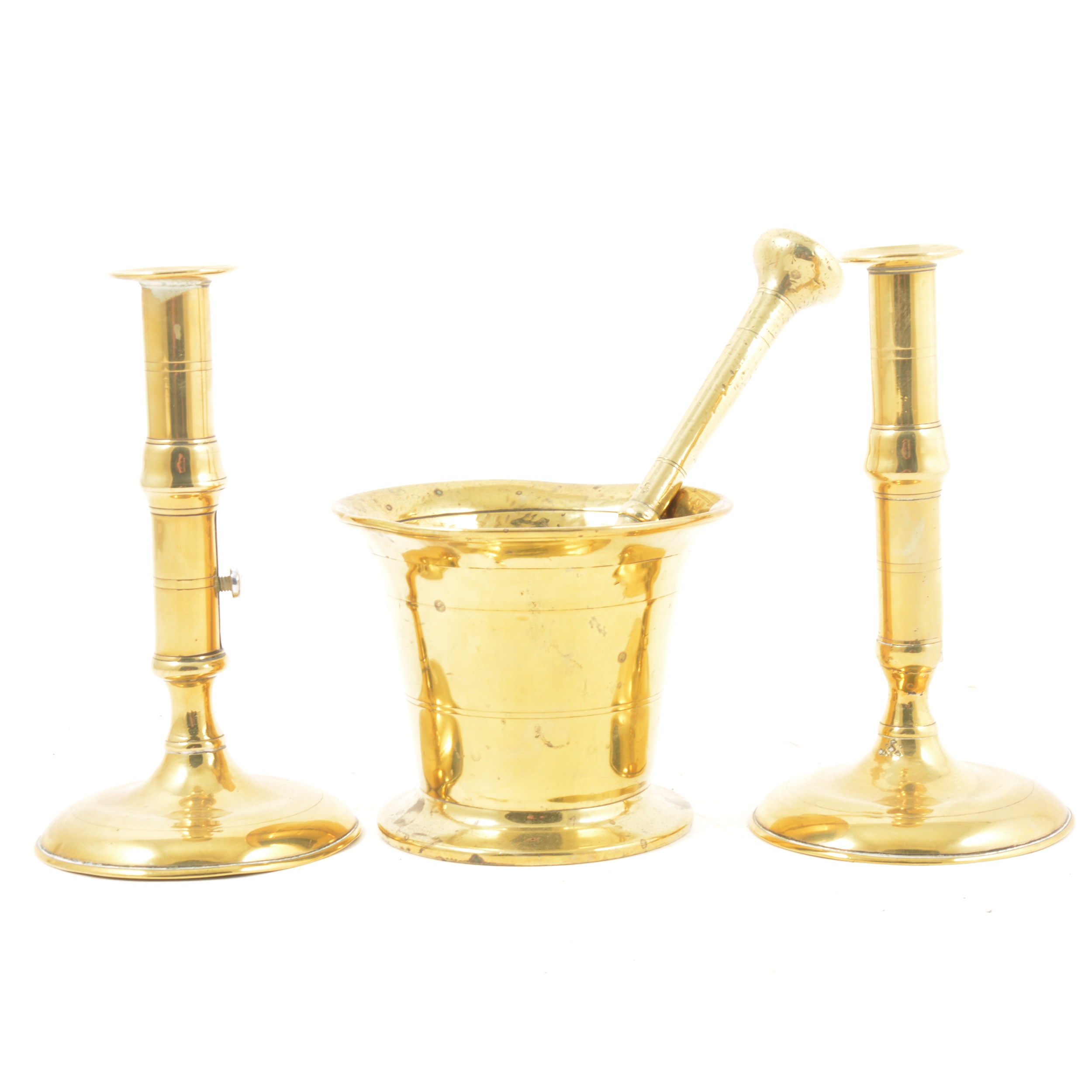 Brass pestle and mortar and a brass candlesticks
