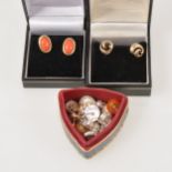 Eleven pairs of earrings for pierced ears, a pair of oval coral studs in 9 carat gold,
