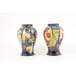 A pair of Moorcroft Pottery 'Queens Choice' vases, designed by Emma Bossons