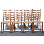 Set of four Arts & Crafts inspired oak wavy ladder-back dining chairs,