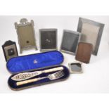A cased set of silver fish servers and collection of pewter, plated and silver photograph frames