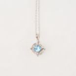 A blue topaz and diamond pendant and chain.
