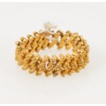 A yellow metal expanding bracelet, 8mm wide, child’s small size.
