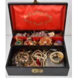 A collection of costume jewellery and wristwatches, coloured paste brooches, gilt chains and