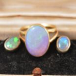 An opal dress ring, pair of stud earrings and pendant.