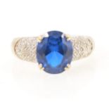 An oval blue paste and diamond ring