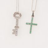 An emerald cross and chain and a sapphire key pendant.