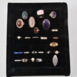 Twenty-five dress rings set with various stones in a black velvet ring tray.