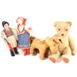 A vintage 1950s straw filled teddy bear, 49cm tall, a straw filled dog, and two character dolls.