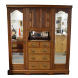 A late Victorian walnut triple wardrobe,