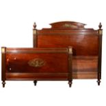 A French walnut and brass inlaid Empire style double bedstead,
