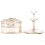 A white metal oval trinket box and a silver ring holder.