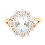 An aquamarine and diamond oval cluster ring.