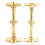 A pair of Victorian Gothic Revival brass altar candlesticks, probably to a design by A.W.N. Pugin