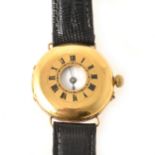 An 18 carat yellow gold lady's half hunter wristwatch on a black leather strap