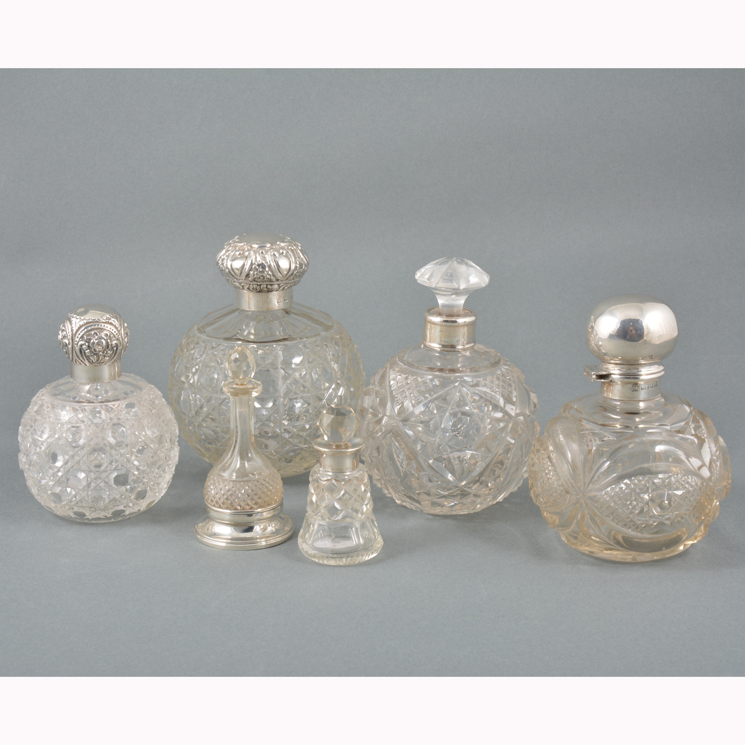 Six cut-glass cologne and scent bottles.