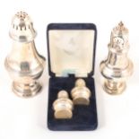 A pair of silver salt and pepper shakers, a silver sugar caster, and a silver-plated sugar caster.