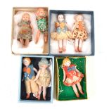 Five miniature bisque dolls house dolls and two similar plastic dolls.