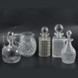 Seven cut glass decanters, pair of perfume bottles and a jug