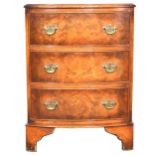 Small walnut bowfront chest of drawers.