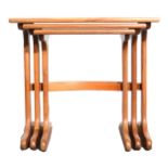 Nest of three teak tables